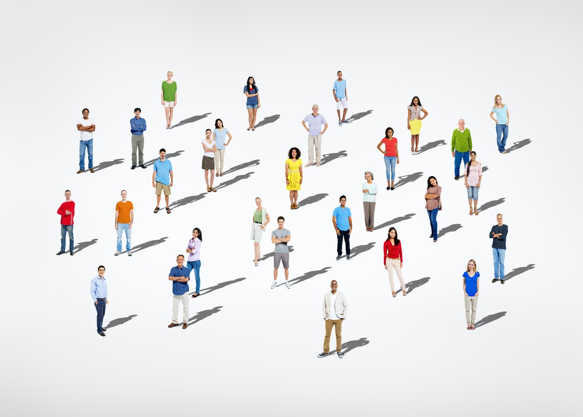 several individuals standing over a white background. picture taken from above.