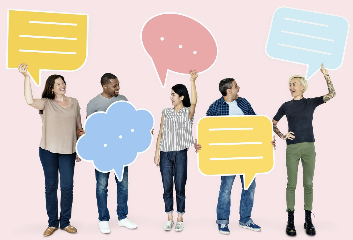 5 people standing up holding conversation bubbles