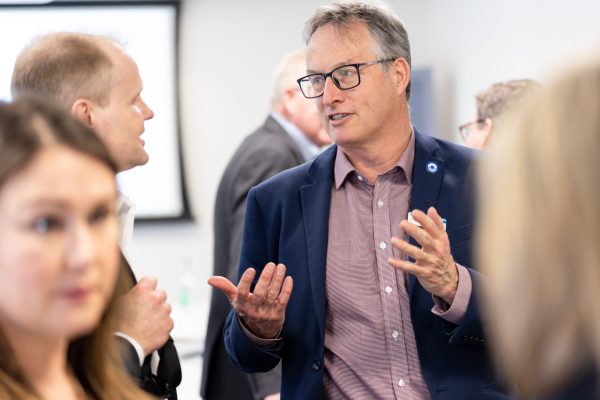 Two men are stood having a conversation
