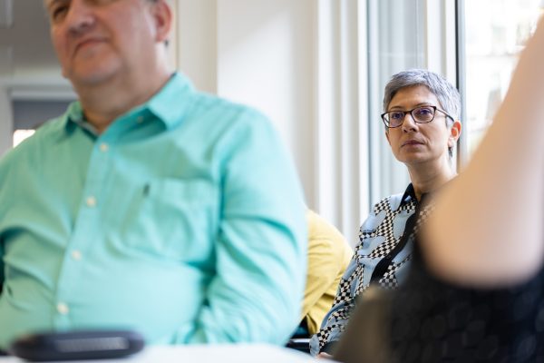A woman is sat listening